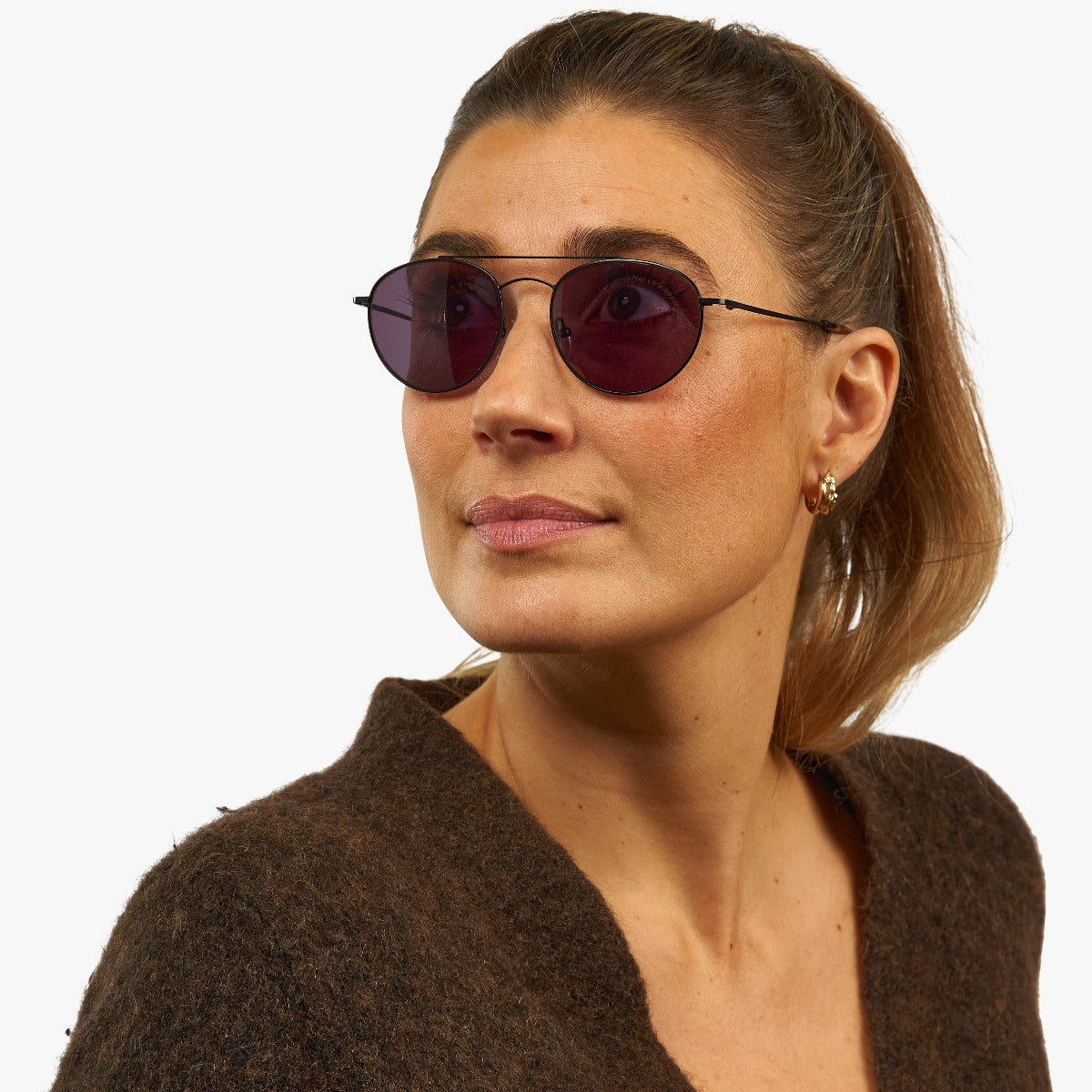 Person wearing Göteborg Black sunglasses with dark lenses and thin black frames