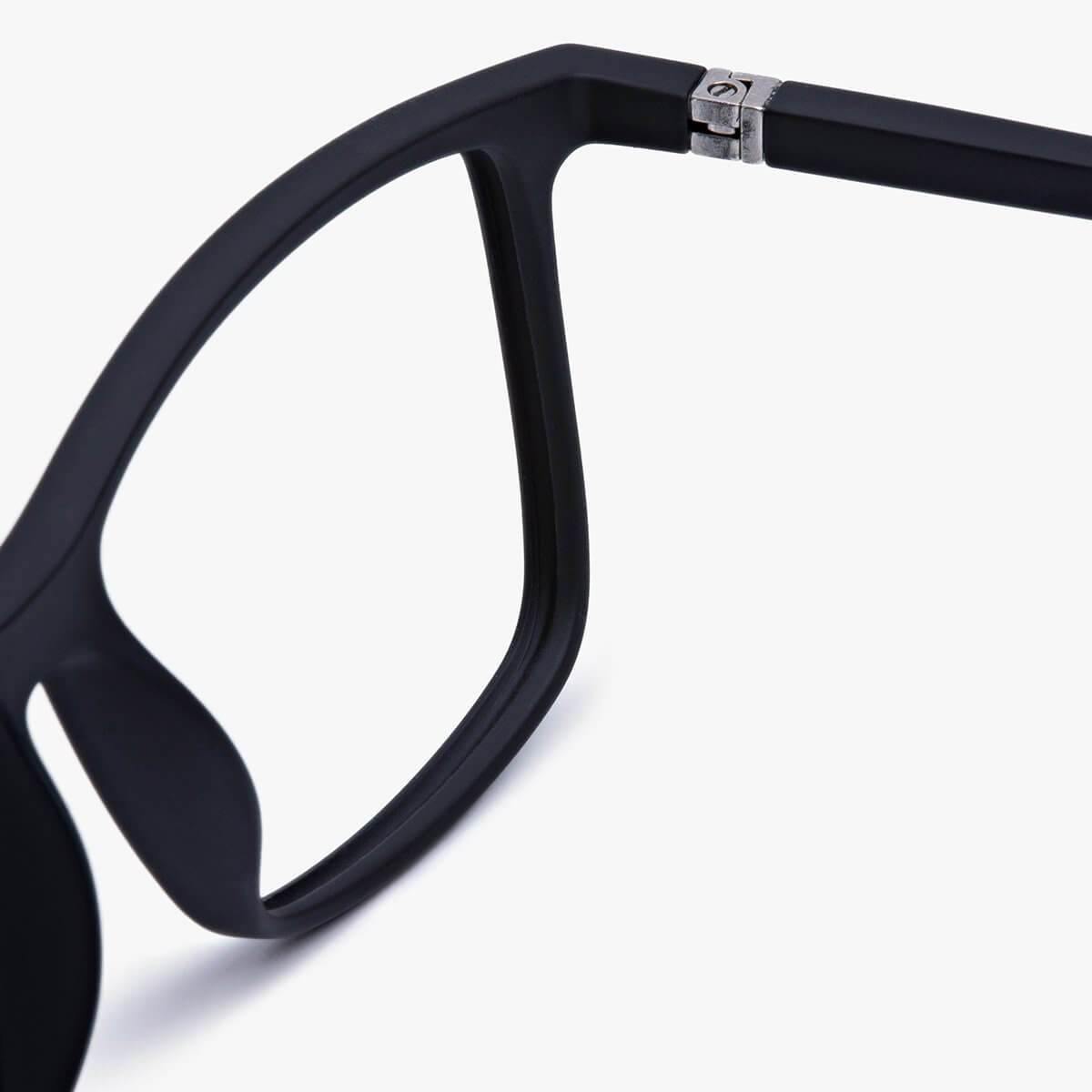 Close-up of black rectangular eyeglasses with matte finish