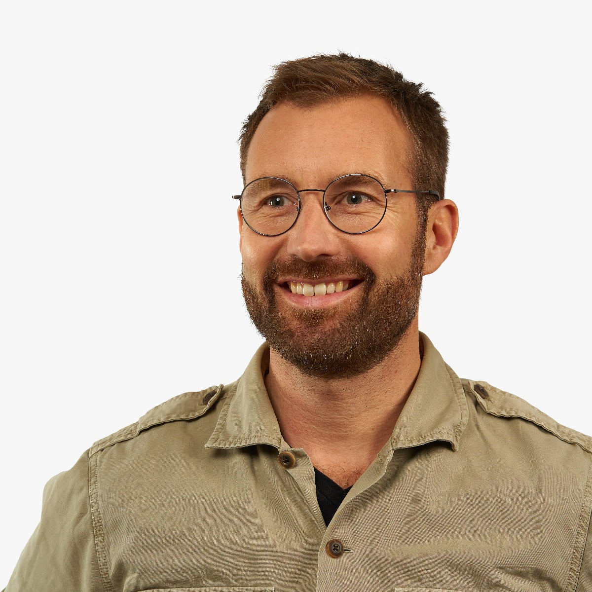 Person wearing thin round glasses with black frames