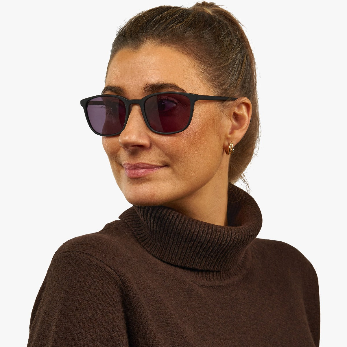 Person wearing Women's Ebeltoft Black sunglasses with dark lenses